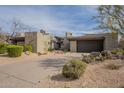 Contemporary home with desert landscaping, a private driveway, and an attached two-car garage at 39493 N 107Th Way, Scottsdale, AZ 85262