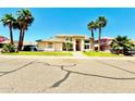 Inviting home with lush landscaping and a well-manicured lawn, under a clear blue sky at 5748 W Soft Wind Dr, Glendale, AZ 85310