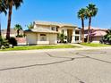 Inviting home with lush landscaping, a desert motif, and a well-manicured lawn at 5748 W Soft Wind Dr, Glendale, AZ 85310