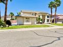 Inviting home with lush landscaping, a desert motif, and a well-manicured lawn at 5748 W Soft Wind Dr, Glendale, AZ 85310
