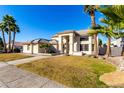 Two-story house with a spacious front yard and palm trees at 5748 W Soft Wind Dr, Glendale, AZ 85310