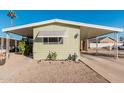 Mobile home with carport and desert landscaping at 6960 W Peoria Ave # 171, Peoria, AZ 85345