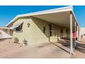 Mobile home with carport and red door at 6960 W Peoria Ave # 171, Peoria, AZ 85345