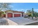 Home exterior showcasing a double garage and desert landscaping at 7575 E Camino Salida Del Sol --, Scottsdale, AZ 85266