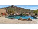 Inviting freeform pool with a natural rock border and desert landscaping at 7575 E Camino Salida Del Sol --, Scottsdale, AZ 85266