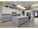 Modern kitchen with gray cabinets and large island at 8308 W Avenida Del Sol --, Peoria, AZ 85383