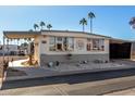 Single-wide manufactured home with carport and partially covered parking at 9501 E Broadway Rd # 178, Mesa, AZ 85208