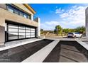 Modern home with attached two-car garage and paved driveway at 1 Easy St # 12, Carefree, AZ 85377