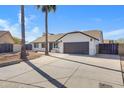 Newly renovated home with a clean, modern exterior and a spacious driveway at 1104 N Oak Ct, Gilbert, AZ 85233