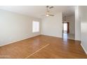 Bright living room with hardwood floors and ceiling fan at 12750 W Dreyfus Dr, El Mirage, AZ 85335