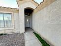 House entrance with a gray door and arched entryway at 13943 S Amado Blvd, Arizona City, AZ 85123