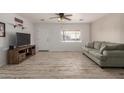 Living room features wood-look floors and a comfy couch at 1510 E Ironwood Dr, Buckeye, AZ 85326