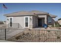 One-story home with gray exterior, a white garage door, and a black metal fence at 17066 W Seldon Ln, Waddell, AZ 85355