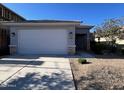 Charming single-story home with a two-car garage and low-maintenance landscaping at 17066 W Seldon Ln, Waddell, AZ 85355
