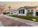 White two-story house with black shutters, palm trees, and a grassy lawn at 255 W Seagull Pl, Chandler, AZ 85286