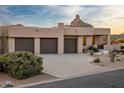 Contemporary home featuring a three-car garage and desert landscaping at 25838 N 104Th Pl, Scottsdale, AZ 85255