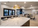 Modern kitchen island with white marble countertops and breakfast bar at 25838 N 104Th Pl, Scottsdale, AZ 85255