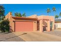 Tan stucco house with a pink garage door and a gravel driveway at 26430 S Pinewood Dr, Sun Lakes, AZ 85248