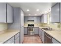 Galley kitchen with stainless steel appliances and light gray cabinets at 26430 S Pinewood Dr, Sun Lakes, AZ 85248