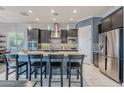 Modern kitchen with stainless steel appliances and a large island at 27648 N 102Nd Ln, Peoria, AZ 85383