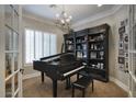 Music room featuring a grand piano and built-in shelving at 280 N 159Th St, Gilbert, AZ 85234