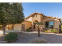 One-story house with tan exterior, arched entry, and desert landscaping at 31032 N Obsidian Dr, San Tan Valley, AZ 85143