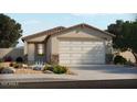 Single-story home with a two-car garage and desert landscaping at 3208 E Hayden Rose Ave, San Tan Valley, AZ 85143