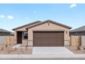 Charming single-story home with a two-car garage and desert landscaping on a sunny day at 3208 E Hayden Rose Ave, San Tan Valley, AZ 85143