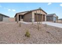 Single-story home with two-car garage, desert landscaping and walkway to front door at 3208 E Hayden Rose Ave, San Tan Valley, AZ 85143