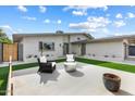 Inviting front patio with artificial turf and modern seating at 3929 E Mercer Ln, Phoenix, AZ 85028