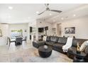 Open concept living area with leather sectional sofa and dining area at 3929 E Mercer Ln, Phoenix, AZ 85028