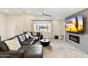 Spacious living room featuring a fireplace and large TV at 3929 E Mercer Ln, Phoenix, AZ 85028