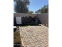 An inviting backyard patio area with brick pavers and a custom rock garden feature at 4714 E Broadway Rd, Phoenix, AZ 85040