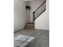 Living room showcasing gray tile flooring, a staircase with black rails, and modern design at 4714 E Broadway Rd, Phoenix, AZ 85040