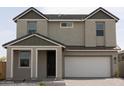 Two-story house with green and gray siding, white garage door, and landscaping at 5814 S Daisy Patch Pl, Phoenix, AZ 85040