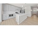 Modern kitchen with gray cabinets, white counters, and island at 615 N Vine St, Chandler, AZ 85225