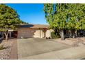 Front view of a single-story house with a large driveway at 6258 E Ivy St, Mesa, AZ 85205