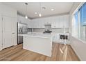 White kitchen with stainless steel appliances and an island at 630 W Laredo St, Chandler, AZ 85225