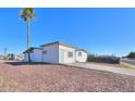 Side view of the house showcasing additional parking at 6649 W Orange Dr, Glendale, AZ 85301