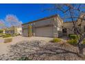 Exterior view of house with desert landscaping and two-car garage at 6730 E Hermosa Vista Dr # 75, Mesa, AZ 85215