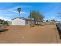 Large backyard with mature trees, desert landscaping and wood fence at 8155 E Baltimore St, Mesa, AZ 85207