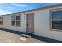 Home featuring a neutral colored front door, neutral exterior paint and desert landscaping at 8155 E Baltimore St, Mesa, AZ 85207