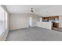 Open living room with grey carpet and a view of the kitchen at 8155 E Baltimore St, Mesa, AZ 85207