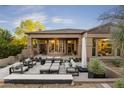 Spacious backyard patio with seating and views of the home's interior at 9280 E Thompson Peak Pkwy # 15, Scottsdale, AZ 85255