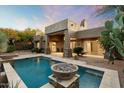 Inviting pool and spa area with fire pit; perfect for entertaining at 9926 E Hidden Green Dr, Scottsdale, AZ 85262