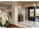 Elegant entryway with ornate door, decorative console table, and high ceilings at 10040 E Happy Valley Rd # 297, Scottsdale, AZ 85255