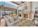 Spacious living room with cozy furniture, a fireplace, and a patterned rug provides an inviting atmosphere at 10040 E Happy Valley Rd # 297, Scottsdale, AZ 85255