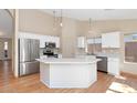 Modern kitchen featuring white cabinetry, stainless steel appliances, and a large island at 10927 E Cholla Rd, Mesa, AZ 85207