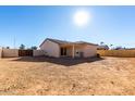 Large backyard with a covered patio and a wooden fence at 16008 N Hollyhock St, Surprise, AZ 85378