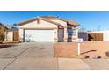 House exterior featuring a single-car garage and well-maintained landscaping at 16008 N Hollyhock St, Surprise, AZ 85378